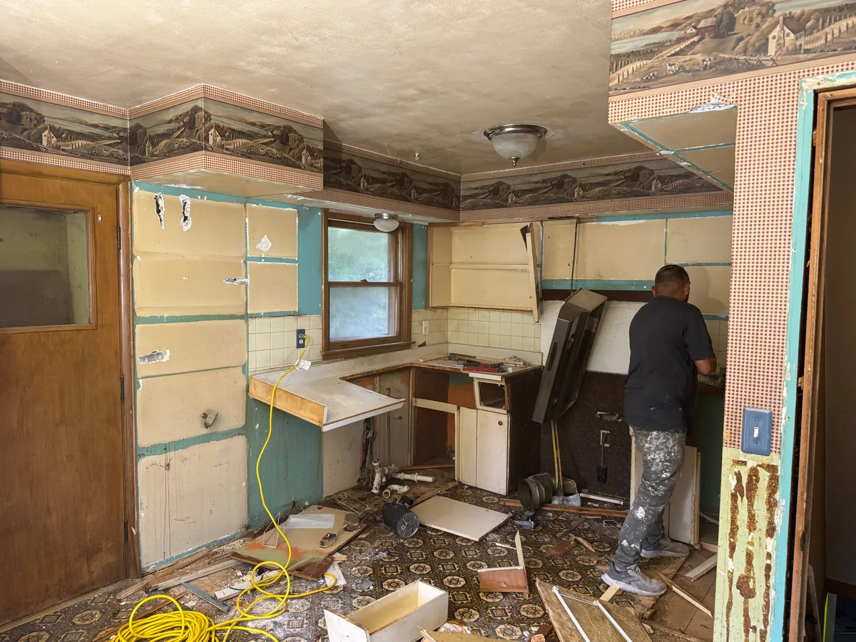 Kitchen cabinets and counters torn out during a house gut out, interior demolition