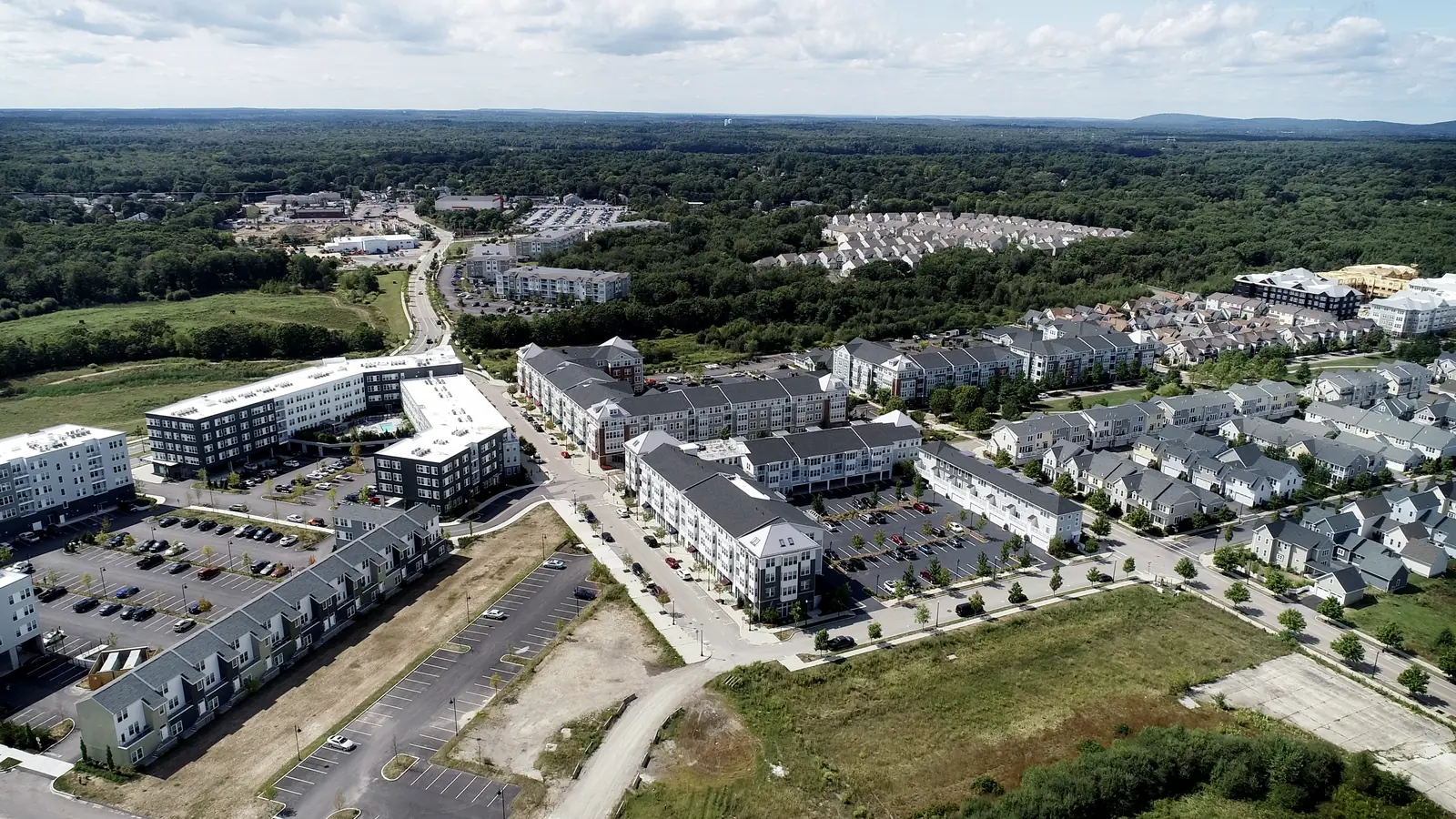 Aerial view of new homes and apartments on a redeveloped former air station site in Weymouth, demolition and masonry contractor
